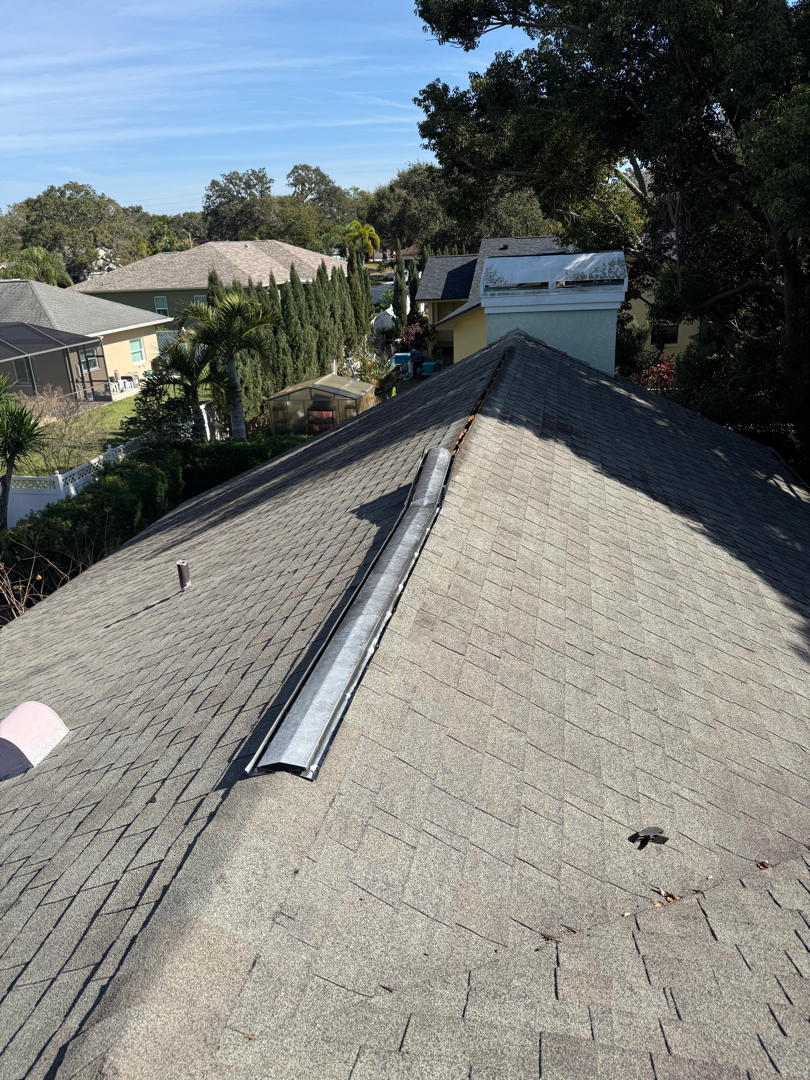 Shingle roof repair. Ridge vent replacement. weathered wood ridge cap photo 2
